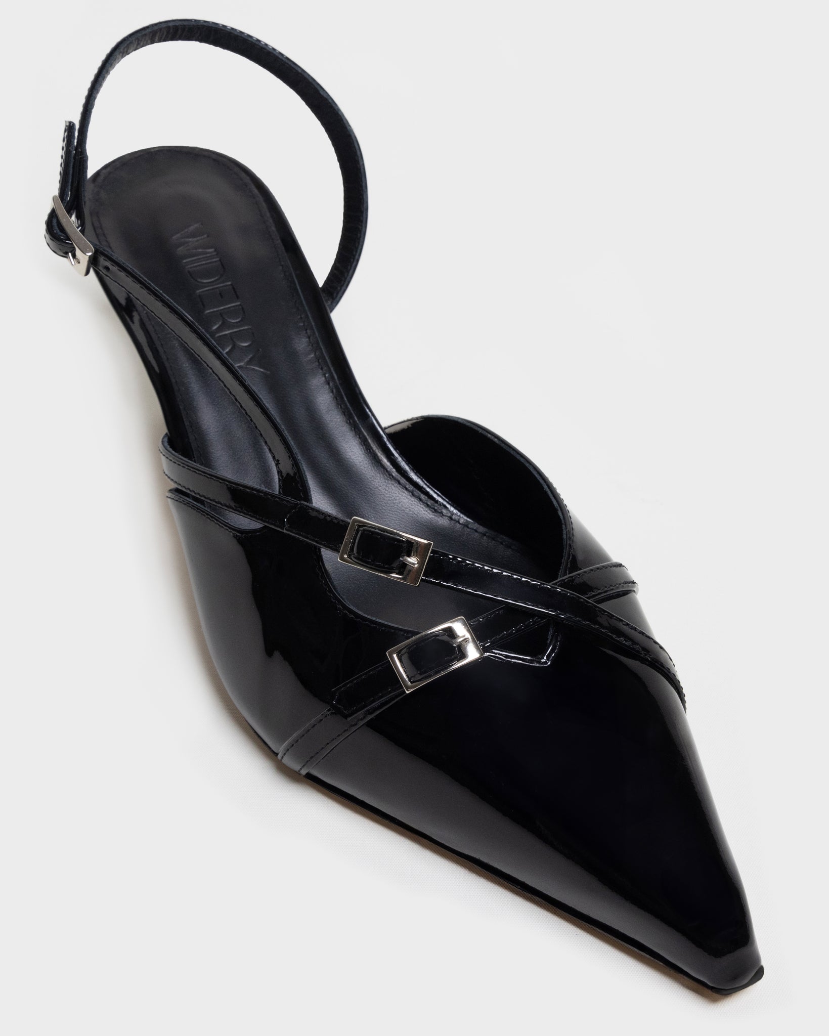 Close-up view of black wide fit kitten heel with patent leather finish, stylish and comfortable women's shoes